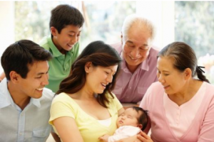 asian family looking at new baby